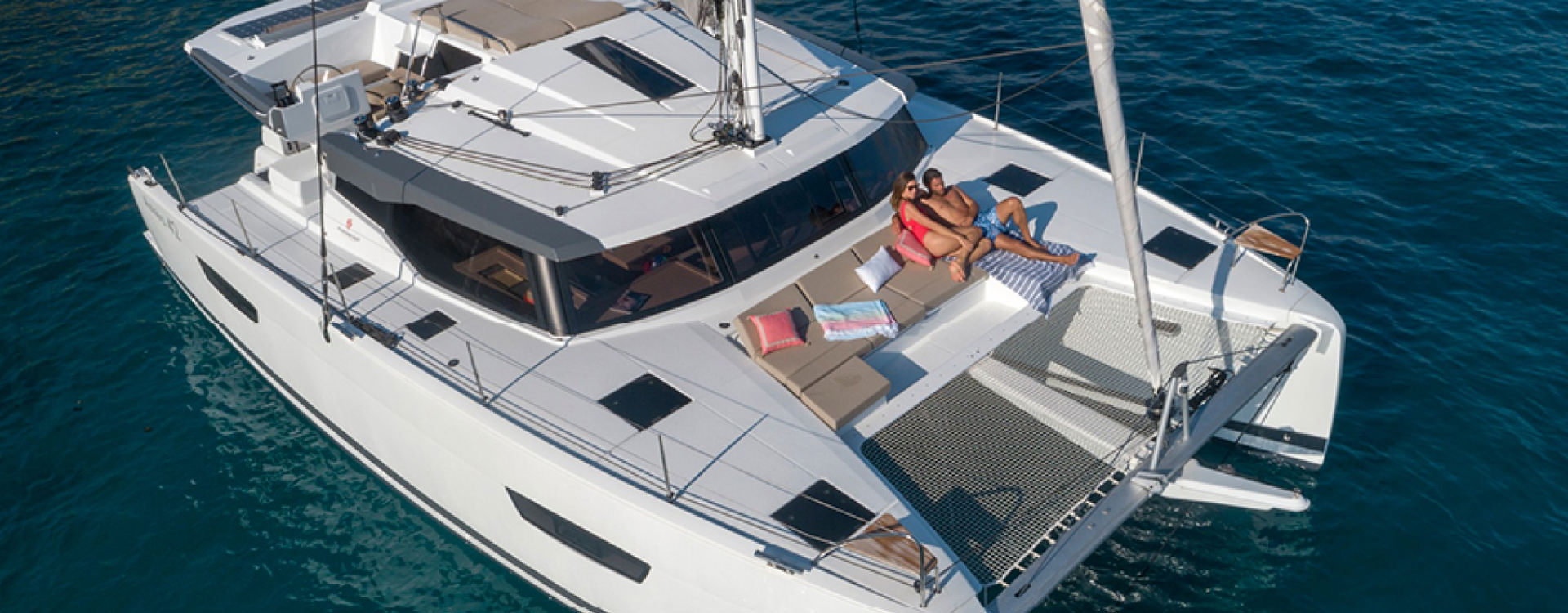 Alni Sailing - Fountaine Pajot Astréa 42 - external view with two people on deck